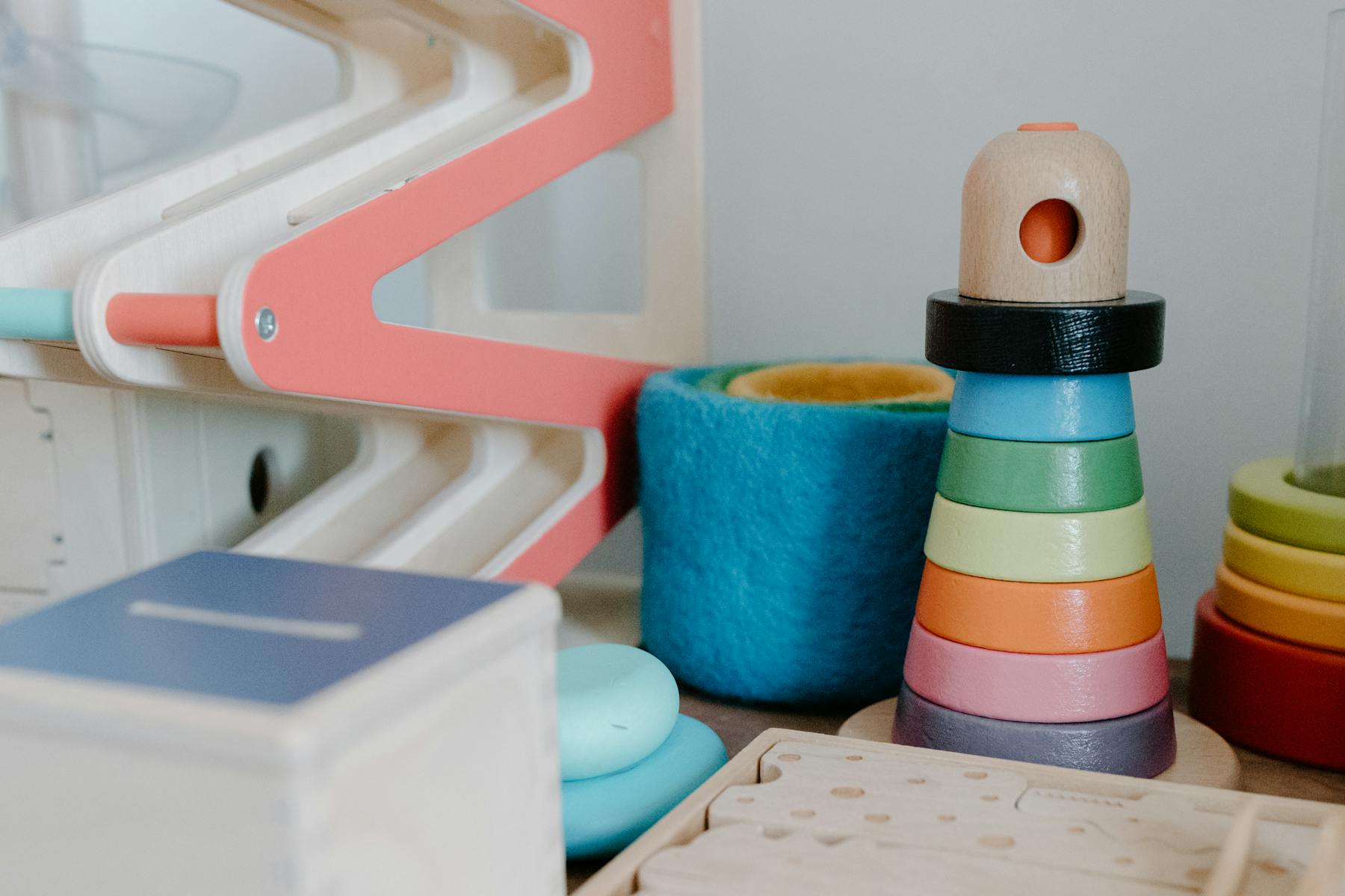 A well-organised display of colourful toy blocks and dolls.